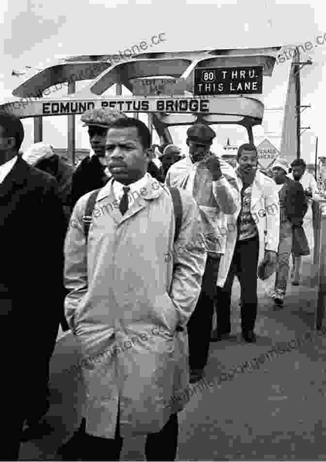 A Black And White Photo Of John Lewis Marching In Selma, Alabama, In 1965. He Is Wearing A Suit And Tie And Carrying A Sign That Reads March: One John Lewis