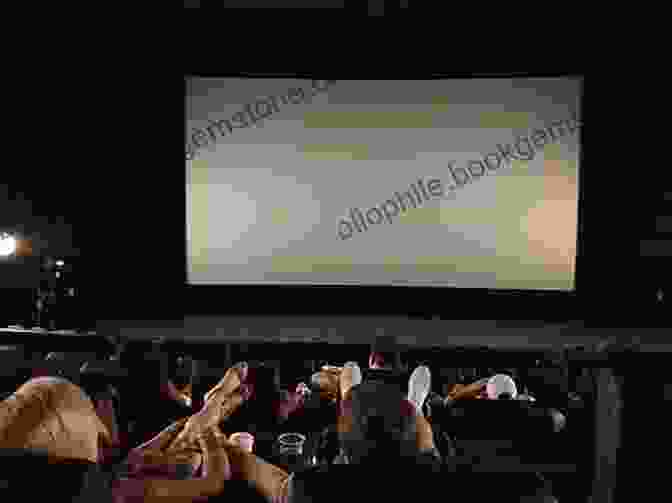 A Group Of People Watching A Film On A Screen In A Movie Theater, Representing The Enduring Legacy Of Stanley Kubrick's Cinema A Critical Companion To Stanley Kubrick (Critical Companions To Contemporary Directors)