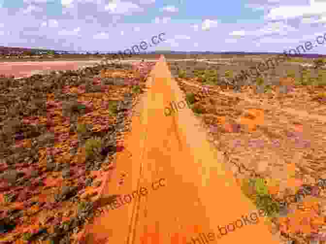 A Long, Winding Red Dirt Road Disappearing Into The Horizon, Surrounded By Vast Plains And Blue Skies. Bill S Story: Memories Of Outback Roads And Characters